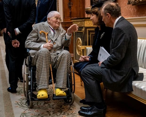 Quirky … David Hockney wears yellow Crocs at the Order of Merit luncheon at Buckingham Palace in 2022. Photograph: Reuters