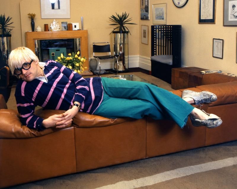 In vogue … Hockney wears a rugby shirt as he lounges on a sofa in his studio and apartment in London in 1972. Photograph: John Hedgecoe/Popperfoto/Getty Images